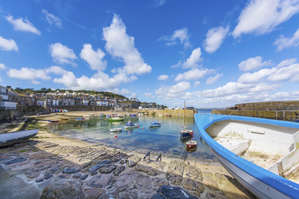 boats in traditional fishing harbour of Mousehole at Cornwall