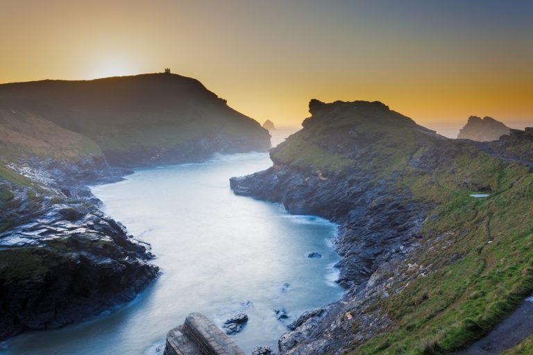 A misty sunset at Boscastle harbour entrance in Cornwall, South West England