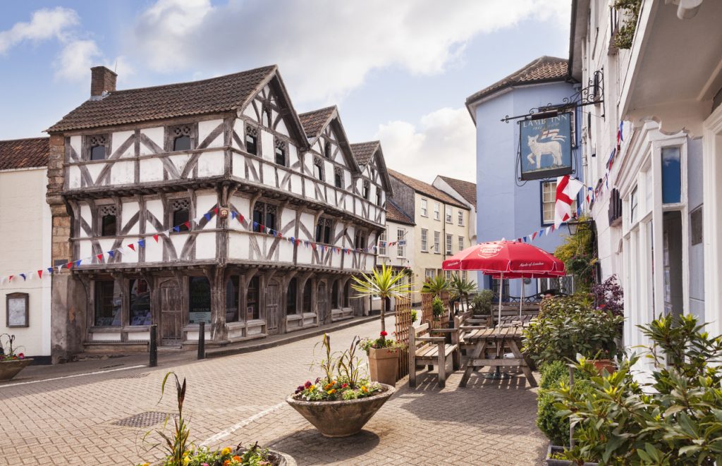 Axbridge, Somerset, England, UK - The medieval square. The half timbered building is King John's Hunting Lodge, now the museum.