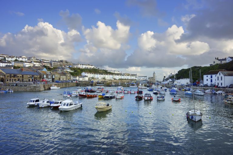 Twilight and soft evening light over moored fishing boats in the inner harbour of Porthleven, Cornwall, United Kingdom
