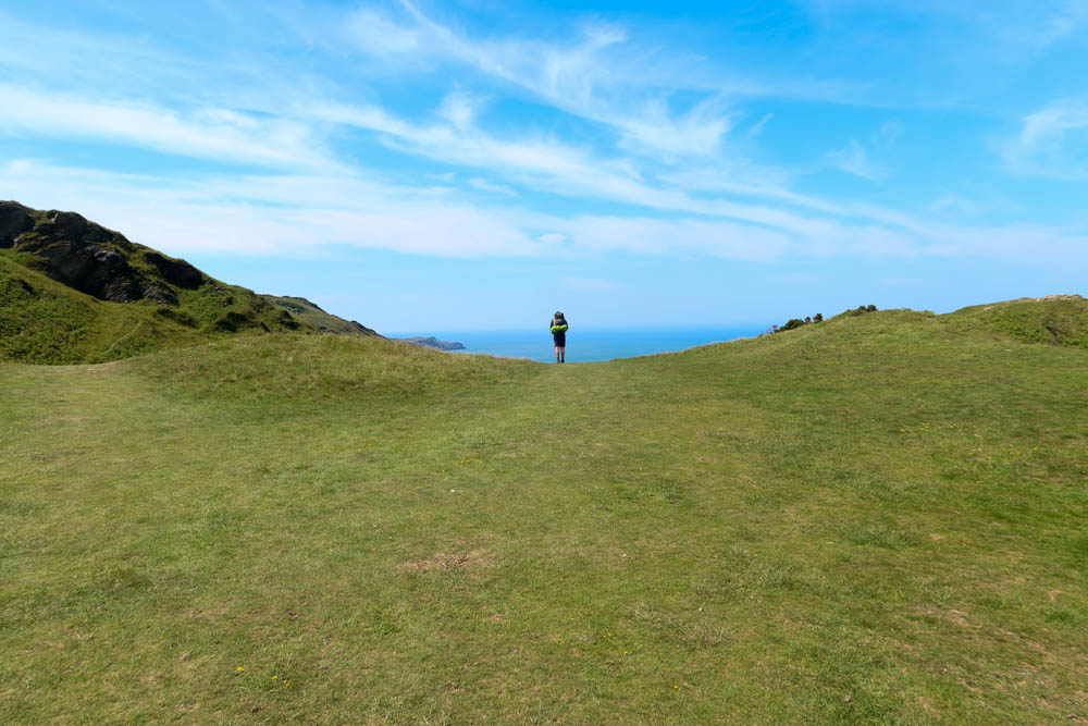 Hiker looking out into the sea between Ilfracombe and Mortehoe