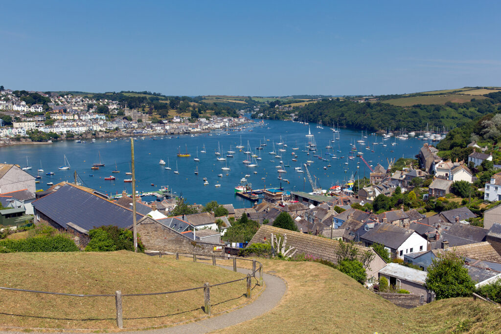 Charming boats on the bright blue Fowey harbour.