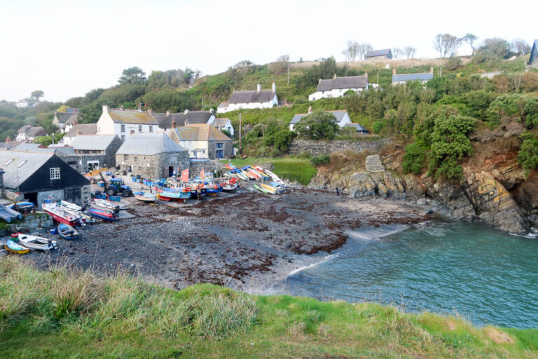 The village of Cadgwith, with thatched roof houses and the picturesque harbour. It's one of the best hidden gems in Cornwall.