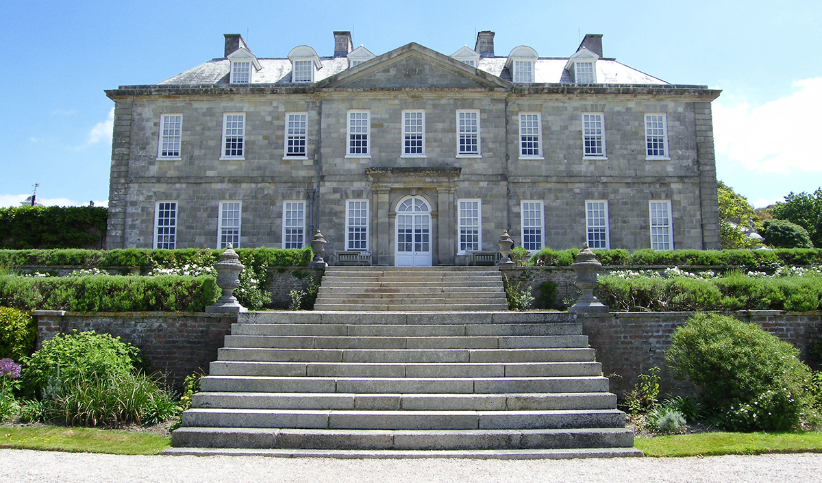 A large house with lots of windows, one of the best National Trust houses in Cornwall.
