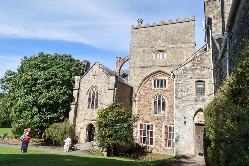 Outside area of Buckland Abbey with historic bricks and blue sky in the background
