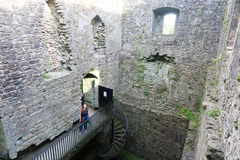 Looking out over the courtyard of Lydford Castle, with a girl on a platform in the background. 
