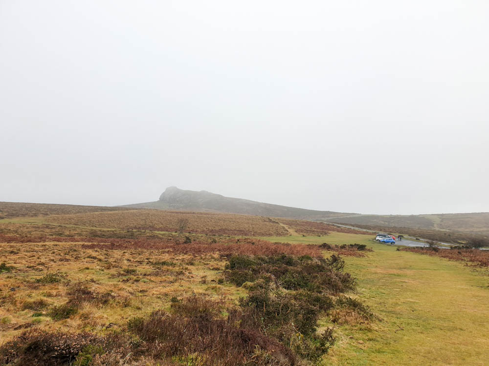A view of Hay Tor Rocks in the background with a foggy landscape