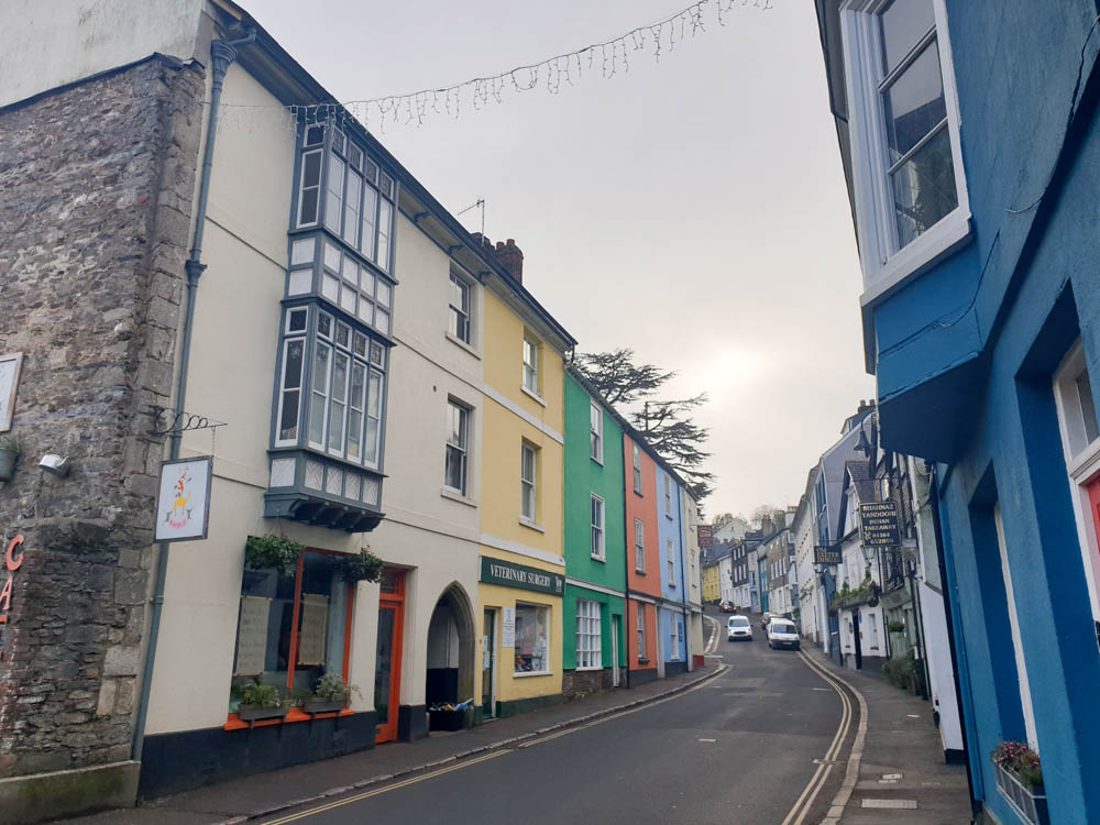 A colourful street in Ashburton, a town in south Dartmoor. There are colourful buildings in a terrace.