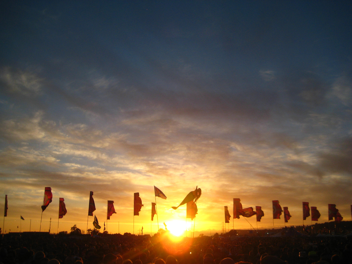 Watching the sunset over the flags by the Other Stage at Glasto '15