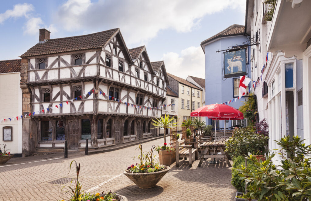9 June 2016: Axbridge, Somerset, England, UK - The medieval square. The half timbered building is King John's Hunting Lodge, now the museum.