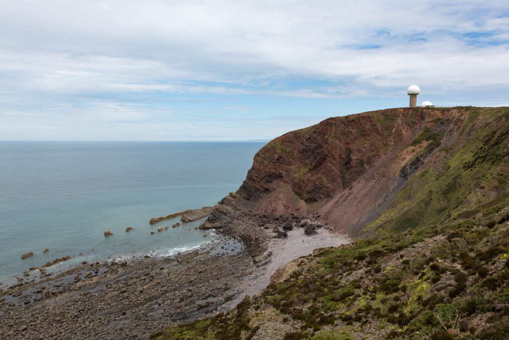 Devon coastline near Shipload Bay with radar tower on clifftop