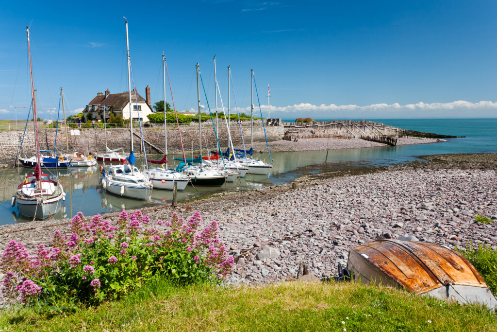 Boats in the outer harbour at Porlock Weir, Somerset England UK