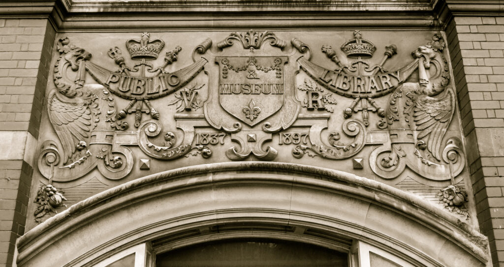 England, Weston-super-Mare - January 31, 2016: Arms plaque above architrave, The Old Library - Boulevard, sepia tone