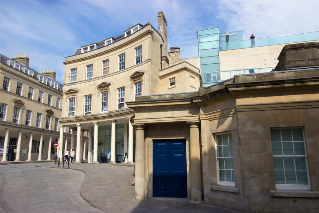 Bath, United Kingdom - May 18, 2014: A view from the front of Thermae Bath Spa, the only spa in the UK using natural thermal waters. Bath has been a spa town since pre-Roman times; its natural pools are said to have been visited by the ancient Celts, and the Romans first built a town and temple there to take advantage of the natural springs. Thermae Bath Spa offers visitors hot mineral pools, aromatherapy steam rooms and spa treatments such as massage and facials.