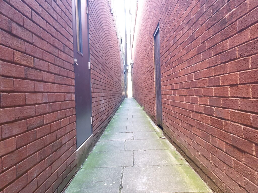 walking down Parliament Street with red bricks on either side