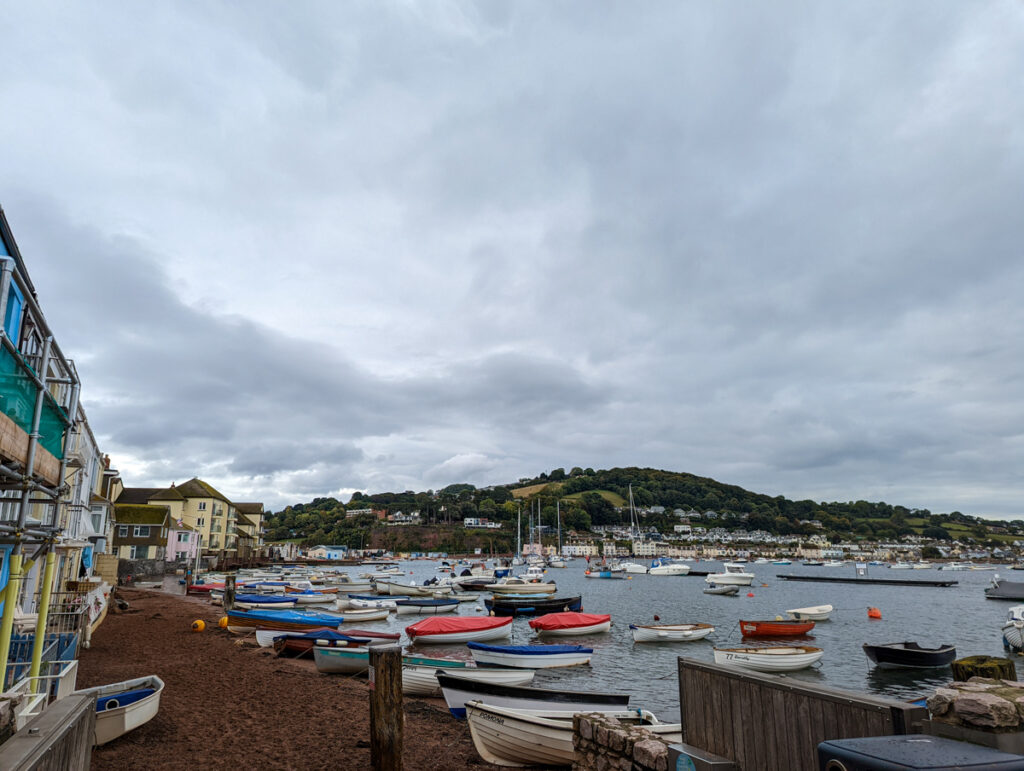 Teignmouth back beach, with boats bobbing on the river estuary