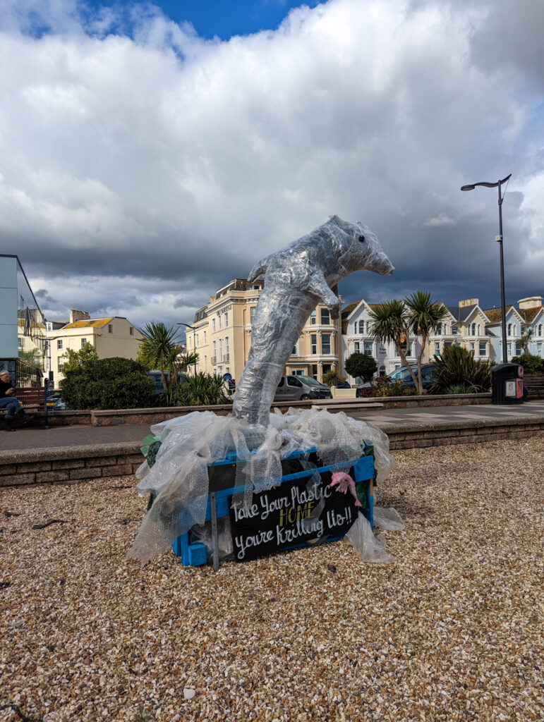 a sculpture of a dolphin on Teignmouth waterfront, part of TRAIL art which runs every summer
