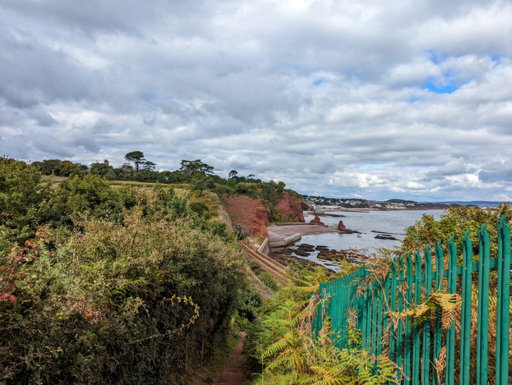 View of red coloured cliffs near Dawlish on the South West Coast Path