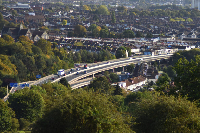 Drone shot of the M32 motorway in Bristol, with trees surrounding it