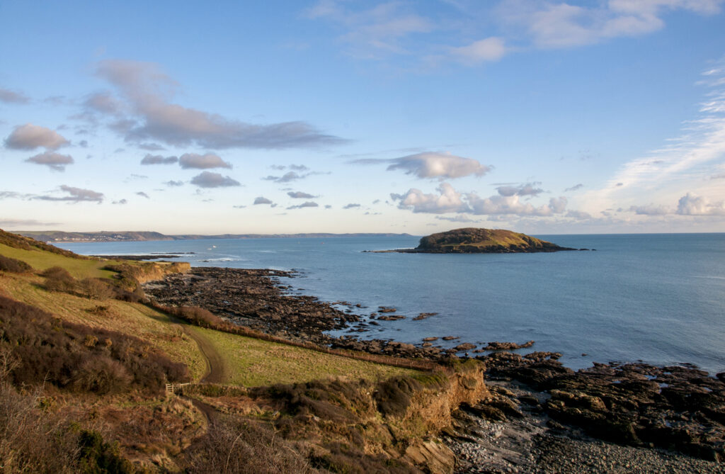 View of the coastline looking towards Looe Island in Cornwall