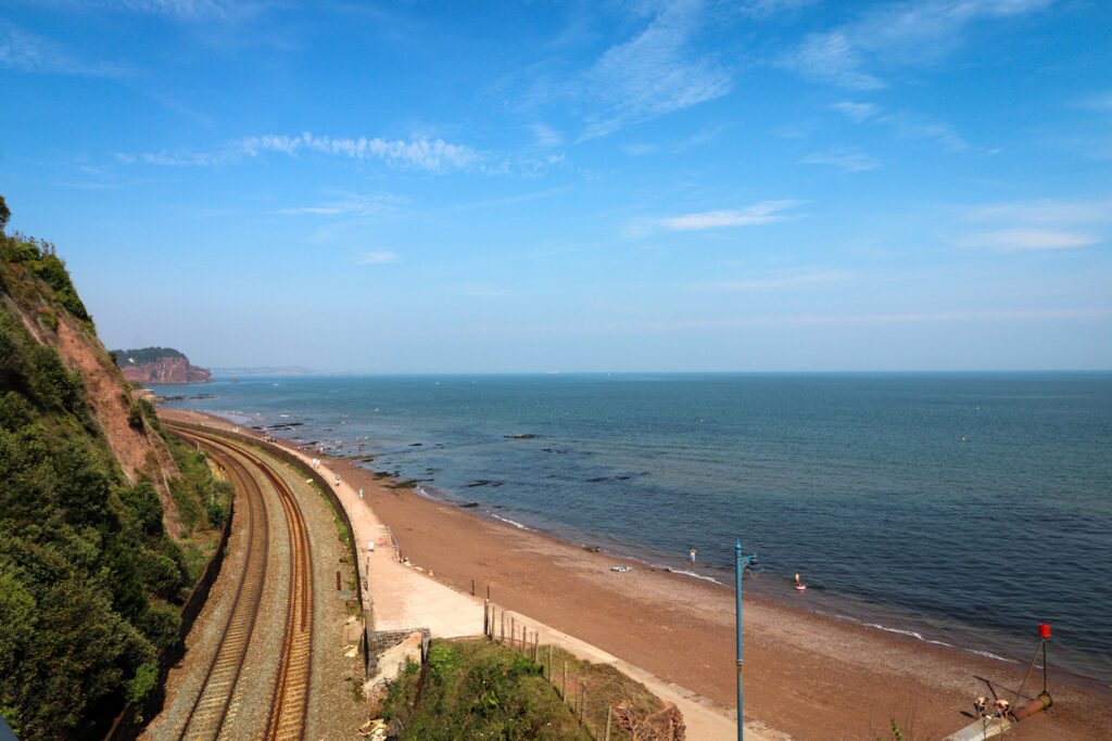 A photograph of Teignmouth beach and railway line in Devon.