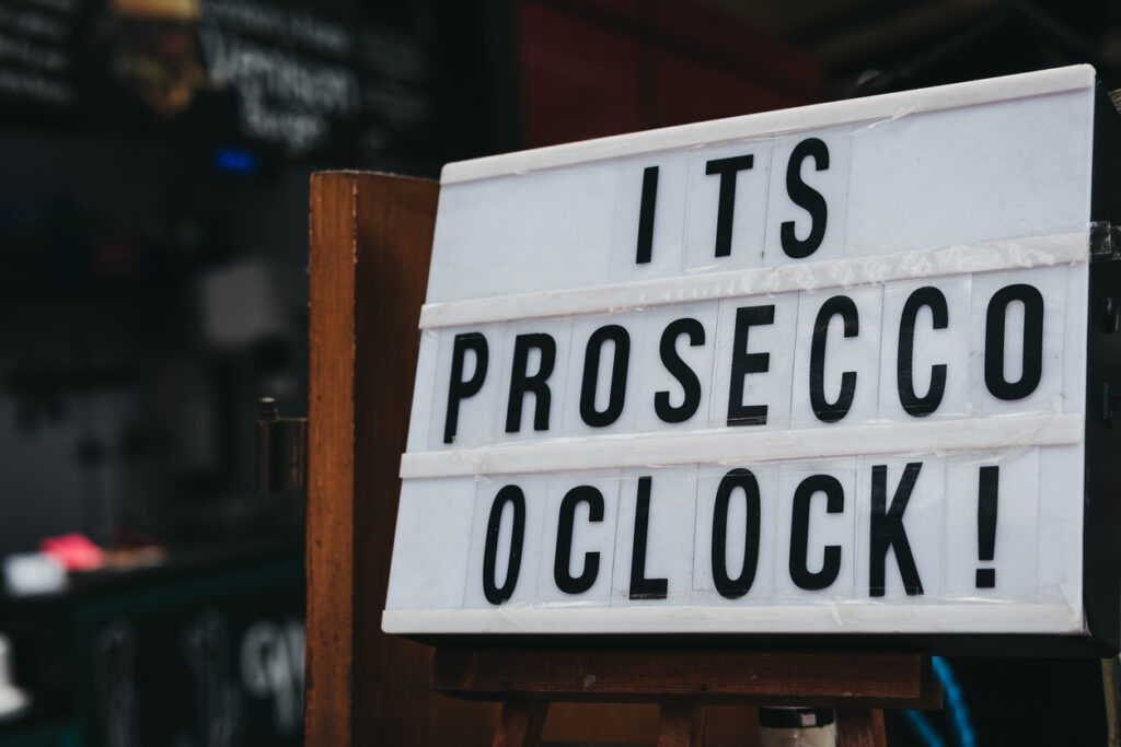 Close up of "It's prosecco o'clock" black and white sign.