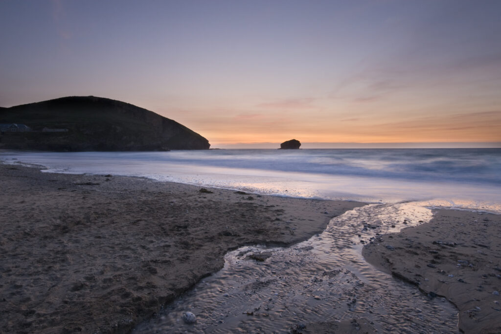 "Portreath Beach at Sunset. This beach is located on the north coast of Cornwall. The photograph show a stream running through the sand to the sea, with the beaches headland and sunset in the background. Image was captured using a long exposure creating movement in the sea and waves. Some more seascape images from Cornwall and Devon in my portfolio:"