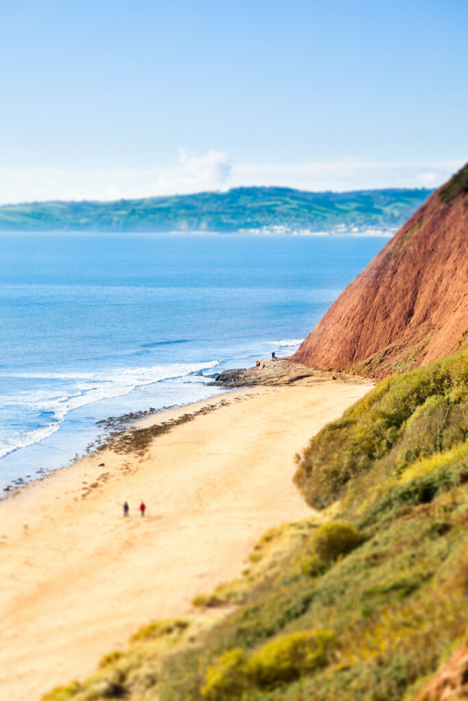 "People  walking on the beach, Exmouth, UK. Tilt shift effect."