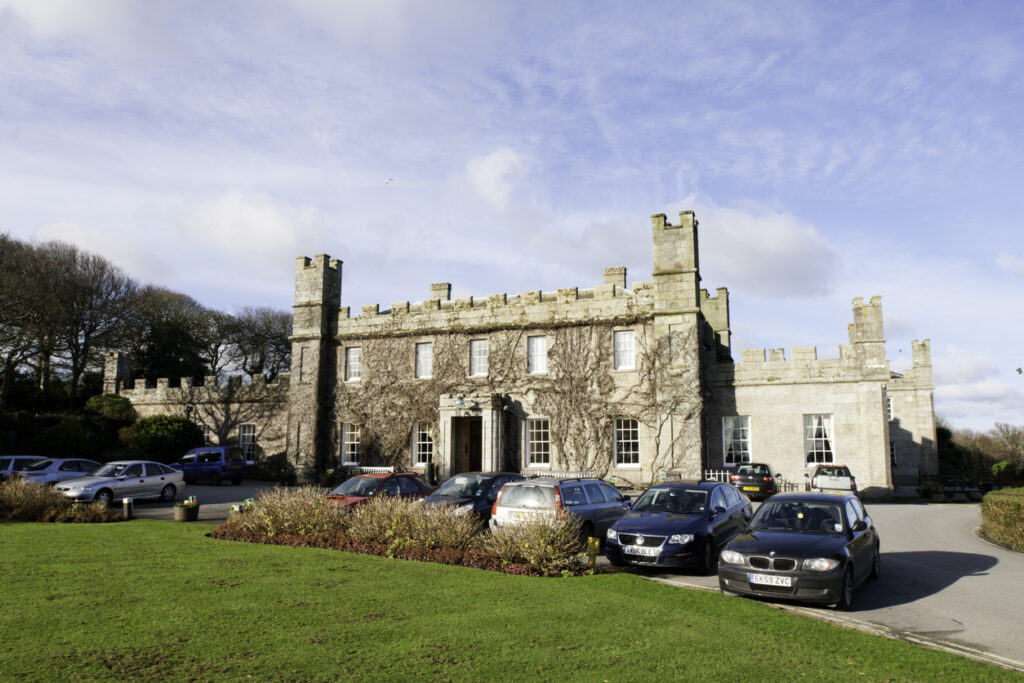 St Ives, United Kingdom - January 28, 2012: Tregenna Castle was built in 1774 by Samuel Stephens as a stately home. The castle is now a popular hotel and wedding venue.  The image shows a full car park and the entrance to the castle, taken on a winters morning.