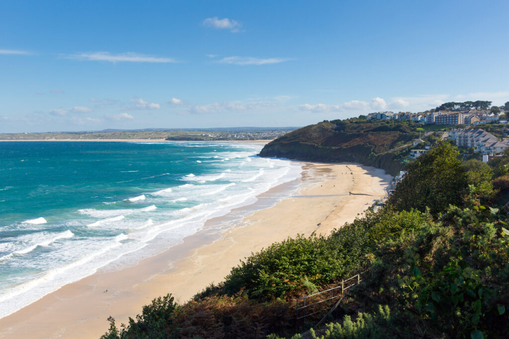 Carbis Bay Cornwall England near St Ives and on the South West Coast Path with a sandy beach and blue sky on a beautiful sunny day