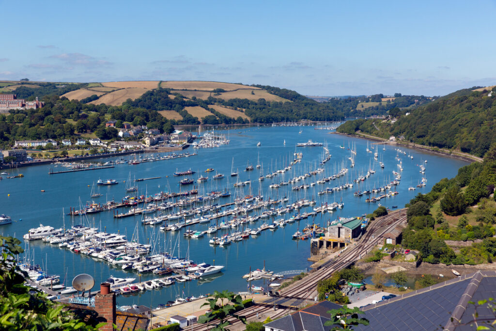 Dartmouth Devon England UK boats and yachts on the River Dart and at harbourside with blue sky in summer