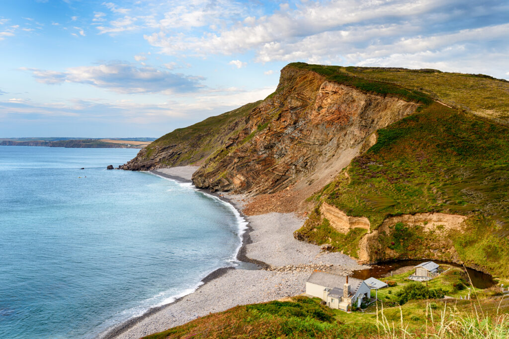 A clifftop view of Millook Haven, a quiet beach on the north coast of Cornwall near Bude