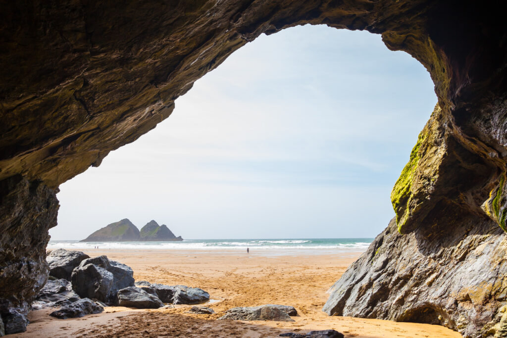 Large cave on the golden sandy beach at Holywell Bay Cornwall England UK Europe