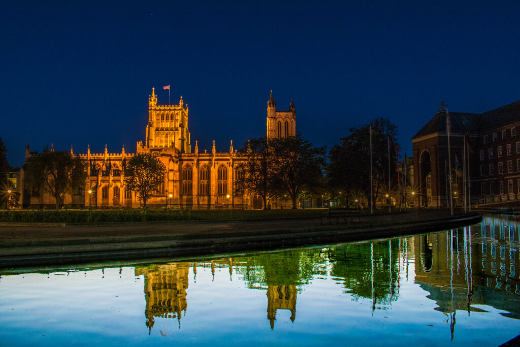 Bristol Cathedral at night with a water reflection taken at day time
