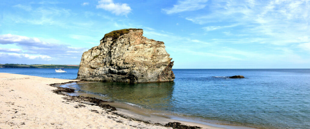 Carlyon Bay, a beautiful beach near St Austell with a rock out to sea. 