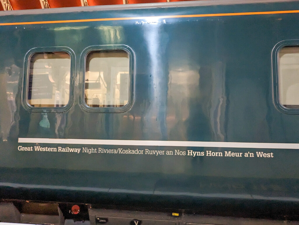 Side of the Night Riviera sleeper service with translations in both English and Cornish