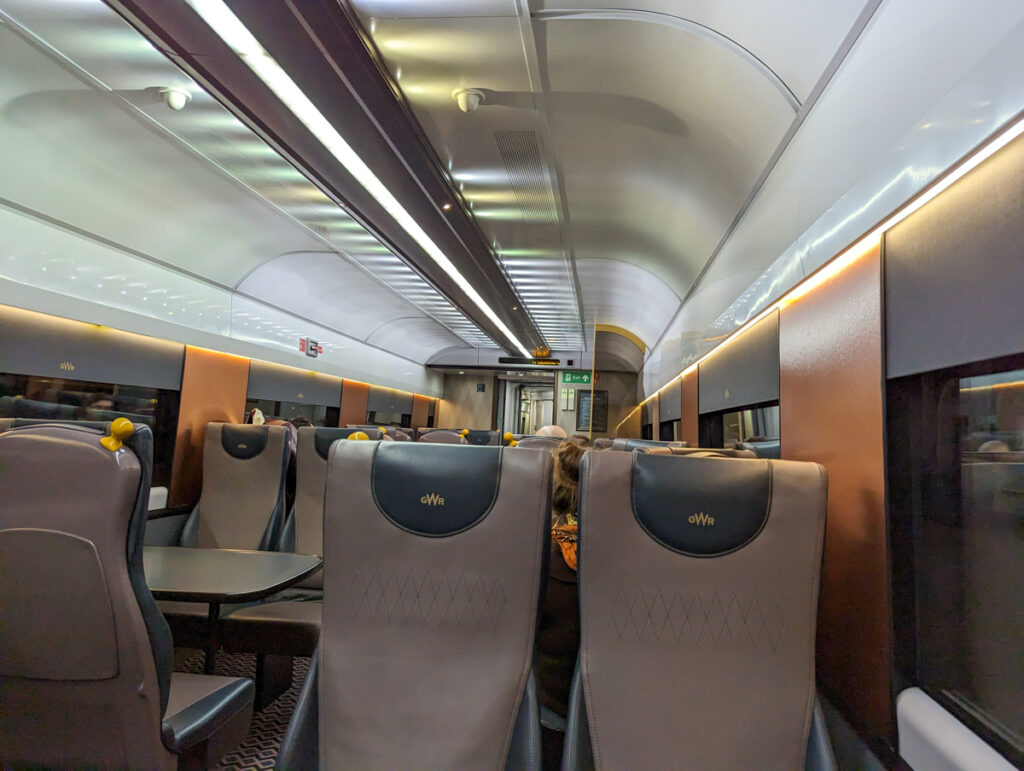 The dining cart on the GWR sleeper service. This shot has the seats in the foreground and the arched roof of the train in the background. 