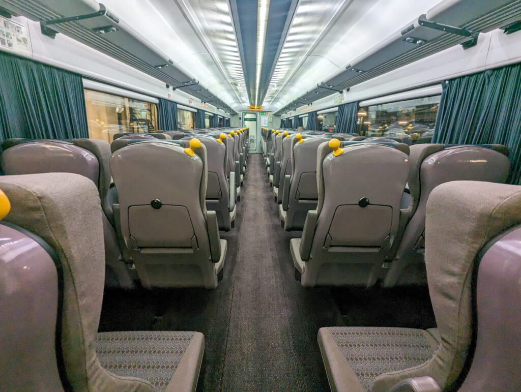 Seated class on the GWR Night Riviera service, which is a row of seats with leg room, USB and plug sockets and wide aisle space.