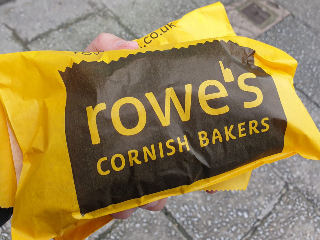 Cornish pasty wrapped up in a yellow paper