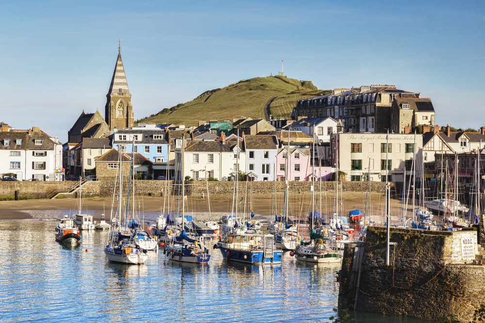 14 June 2017: Ilfracombe, North Devon, England, UK - The harbour on a bright sunny morning in summer, with Capstone Hill in the background.