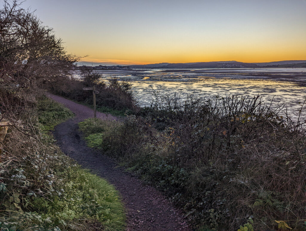 Sunset from a trail over the Exe Estuary, with the trail, water and sky in shot