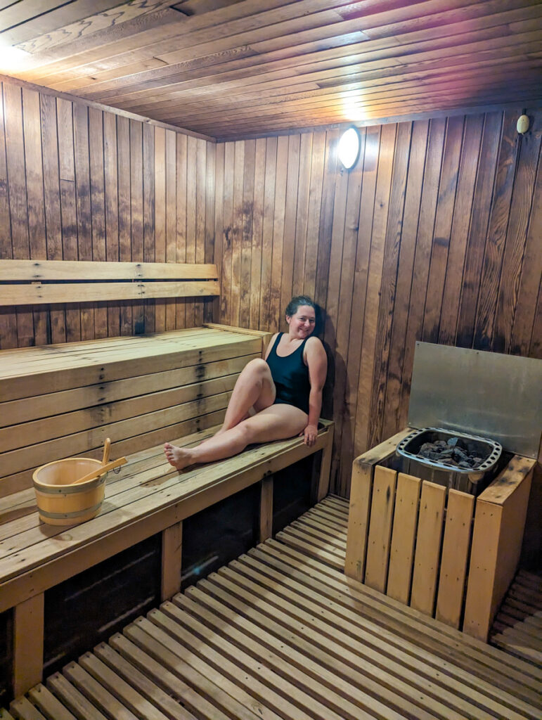 Claire sitting in a sauna, relaxing at the St Moritz hotel
